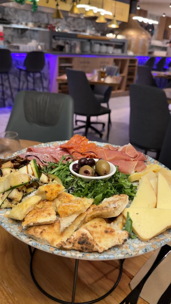 Antipasto platter with cured meats, cheese, olives and bread