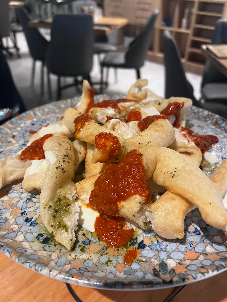 Crisp fried dough with Napoli sauce and creamy cheese