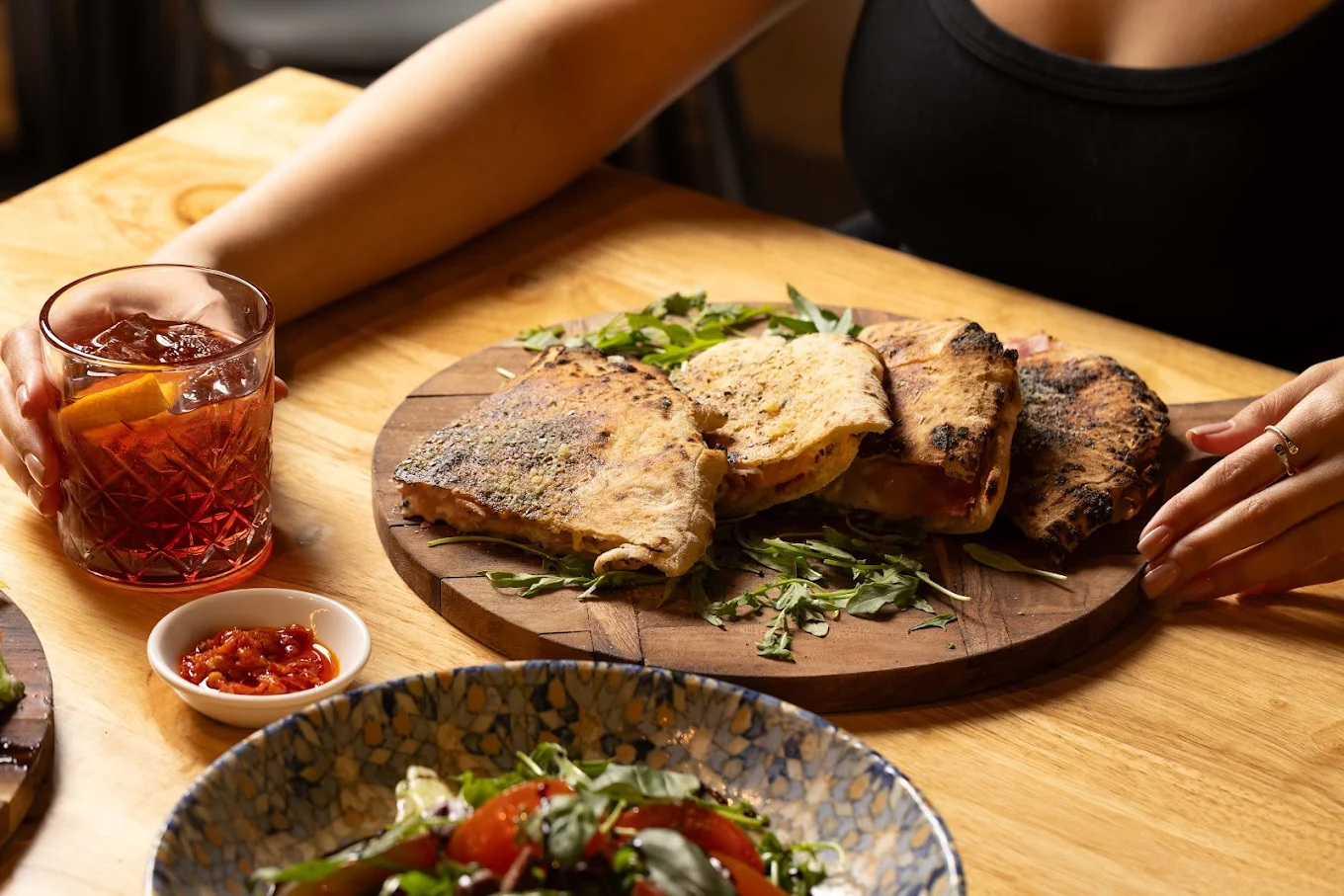 Wood-fired stuffed bread served with an Italian cocktail